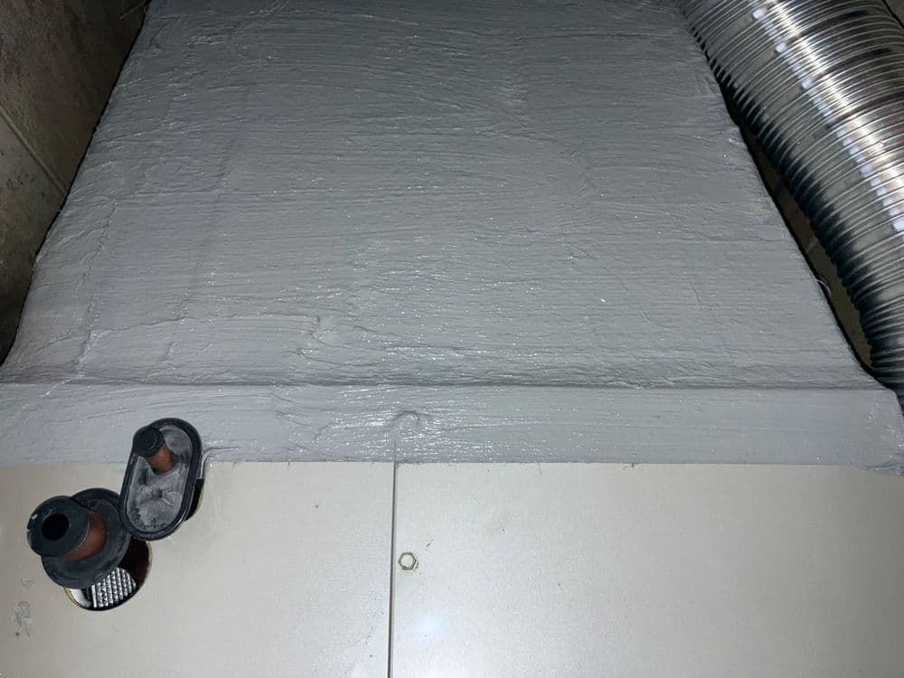 Gray coated surface with ventilation duct and fittings for HVAC system maintenance.